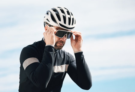 Ready to ride. a handsome mature man taking a break while cycling outdoors.の写真素材