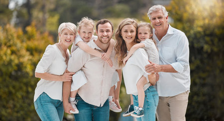 Portrait of multi-generation family standing together. Extended caucasian family smiling while...