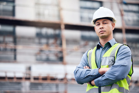 Lets build some new things. a mature male architect standing with his arms crossed at a building...