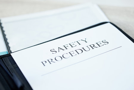 If you work with us, we want to keep you safe. a document with Safety Procedures on it in an office.の写真素材