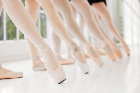 Points of power. a group of ballerinas with toes pointed.の写真素材