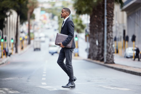 Always look forward in life. a young businessman crossing the street in the city.の写真素材