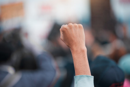 We are the people that rule the world. Cape Town, South African - October 2, 2021 Unrecognisable demonstrators holding up their fists in protest.の写真素材