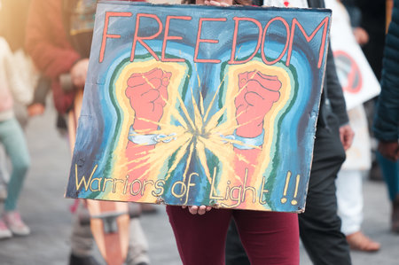 There is no faith in the system. Cape Town, South African - October 2, 2021 Unrecognisable demonstrators holding up signs during a protest.の写真素材