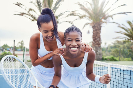 Tennis was always sort of... a learning. two attractive women standing together while playing tennis outside.の写真素材