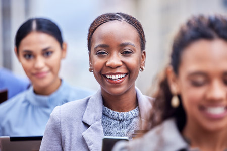Happy to be reaching for her dreams. a group of businesspeople in a line at work.の写真素材