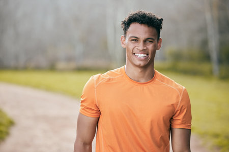 Staying fit is my lifestyle. a handsome young man standing alone outside during his workout.の写真素材