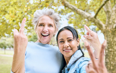 Senior women, park portrait and hand sign for comic, funny and happy time together in nature. Old...