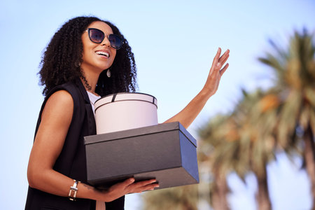 Black woman, shopping and gifts with smile waiting for lift, pickup or travel with fashion clothing...