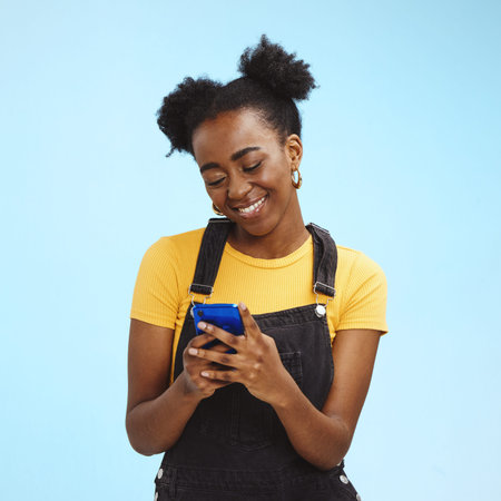 Black woman with smartphone in hands, smile and happy with chat or social media, communication...