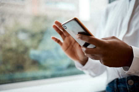 I found a great app to help me manage things. a businesswoman using her cellphone.の写真素材