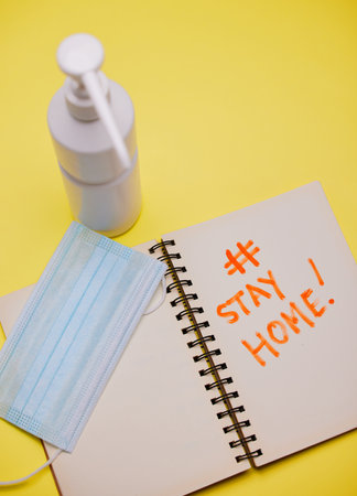 Following protocol carefully. Studio shot of covid equipment against a yellow background.の写真素材
