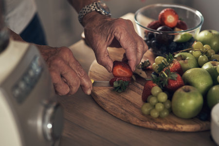 Start your day off with something healthy. an unrecognizable person preparing ingredients for a smoothie at home.の写真素材