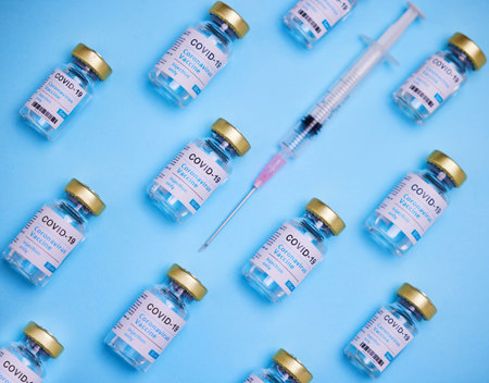 You can get it if you want it. vaccines and a syringe against a blue background.の写真素材
