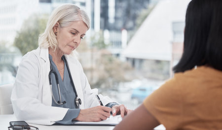 Writing the recipe for healthcare success. a doctor having a consultation with a patient.の写真素材