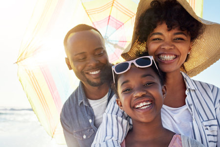 Happy family, smile and beach sunshine portrait together for travel holiday, summer vacation or bonding outdoor. African parents, child happiness and relax quality time on ocean sea for adventureの写真素材