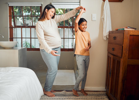 Pregnant mother, child and happy family dancing in home bedroom for bonding, love and care for girl. Smile of kid and woman together in house for pregnancy celebration with happiness and supportの写真素材