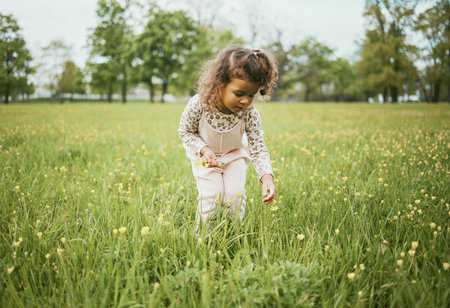 Girl child, field and flowers in nature, outdoor and learning for plants in backyard, park or woods....