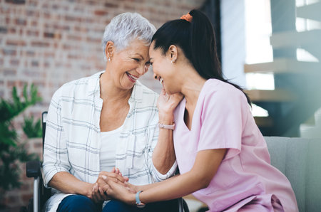 I need her more than she needs me. a young nurse caring for an older woman in a wheelchair.