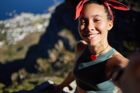 Yip, I conquered this mountain. a young woman taking a selfie while out hiking.の写真素材