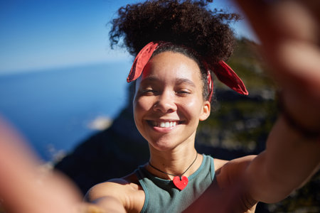 I love shared my adventures. a young woman taking a selfie while out hiking.の写真素材