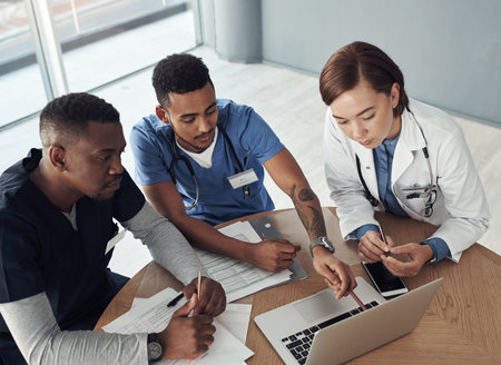 It takes two flints to make a fire. Shot a group of doctors discussing work matters in the office at work.の写真素材