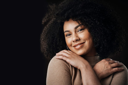 A happy woman is a beautiful woman. Cropped portrait of an attractive young woman posing in studio...