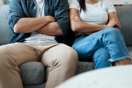Were angry but were still here. a young couple having an argument at home.の写真素材