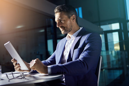 Thinking, tablet and working business man planning with web finance trading analytics. Office, accounting investment employee and boss typing a tech strategy report for a stock market companyの写真素材