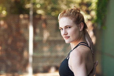Stretch, win, repeat. Cropped portrait of an attractive young female athlete stretching while...