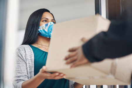 Preventative measures have never been more important than now. a masked young woman receiving a...