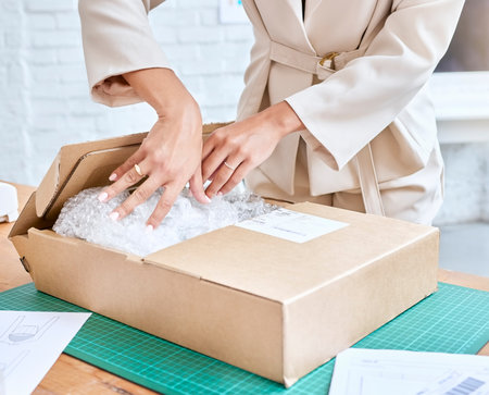 Woman hands, logistics and package in box for delivery, cargo or ecommerce, purchase or inventory at workshop. Hand of business owner packaging item, object or label for deliver, service or saleの写真素材
