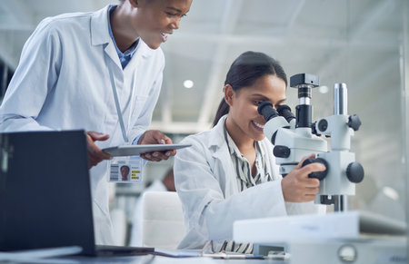 Busy with a day of experiments and observations. two scientists working together in a lab.の写真素材