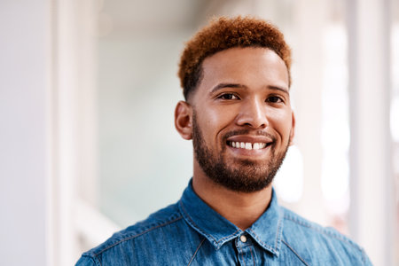 My career keeps me smiling. Cropped portrait of a handsome young male designer standing in his office.の写真素材