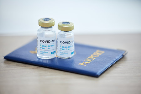 Covid vaccine vial, passport and travel compliance for medical safety, security and international regulation healthcare. Covid 19 virus, medicine and rules for tourism control during corona pandemicの写真素材