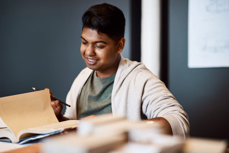 The man to call for innovative interior design. a young architect looking through a notebook at his...