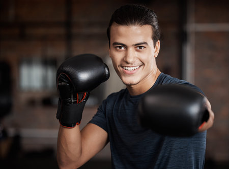 Portrait, fitness and workout with a boxer man training for a fight or competition in a gym for...
