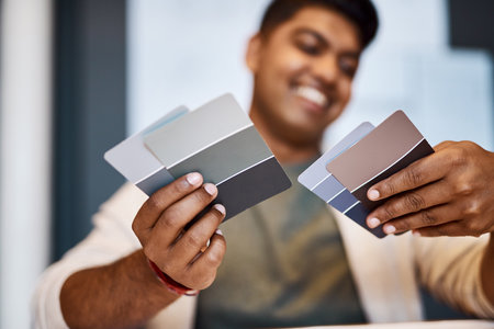 If anything can give a design character, colour will. a young architect deciding on a colour scheme while working on a project.の写真素材
