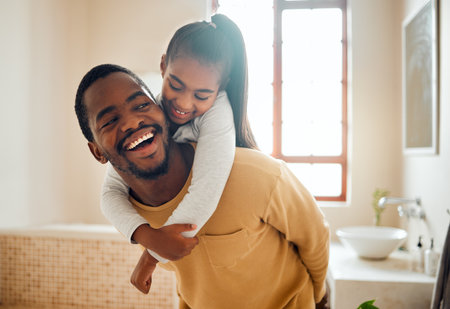 Father, child or black family laughing in happy home with love, care and support while in bathroom. Man and girl kid for a piggy back ride with a smile, energy and hug for safety, health and wellnessの写真素材