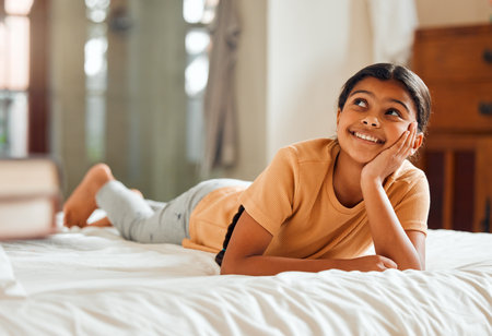 Fantasy, bed and black girl thinking, ideas and relax on weekend, happiness and summer break. African American female child, young lady or daydreaming, imagination and thought with wonder and bedroomの写真素材