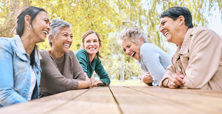 Park table, friends and women laughing at funny joke, crazy meme or comedy outdoors. Comic, happy...