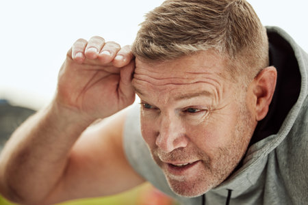 Workout, exercise and senior man tired, training and fitness for wellness, cardio and energy. Mature...