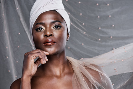 Its impossible not to notice that glow. a beautiful young woman wearing a head wrap.