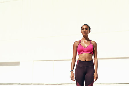 Dont say I want to, just do. an attractive young woman standing outside in sportswear.