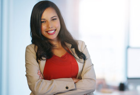 Im happy with how the business is running. Portrait of a confident young businesswoman standing with...