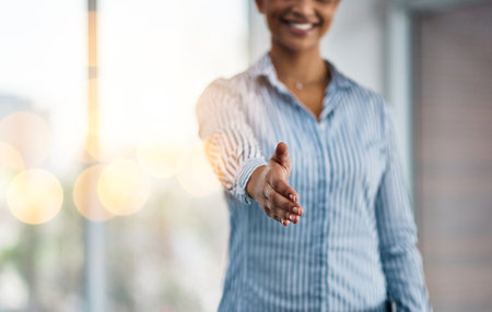 When a big opportunity presents itself, take it. Closeup shot of an unrecognizable businesswoman extending a handshake in an office.の写真素材
