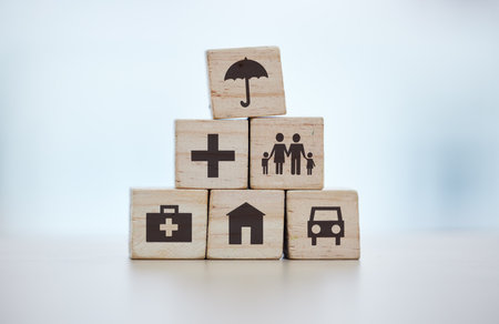 Building blocks, pyramid and life insurance for medical, car loan or home on background mockup, table or desk mock up. Zoom, wooden and cubes for house risk management, security and future protectionの写真素材