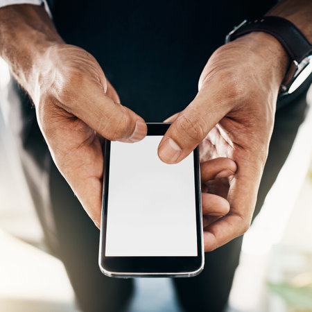 The smartest business resource. a businessman using a mobile phone in an office.