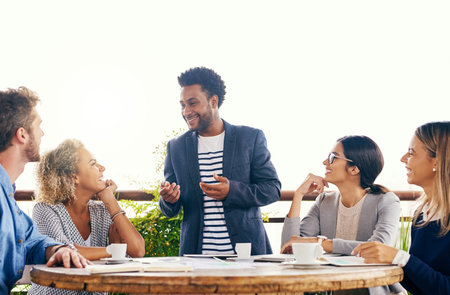 The fresh air brings a breeze of fresh ideas. a group of businesspeople having a meeting outdoors.
