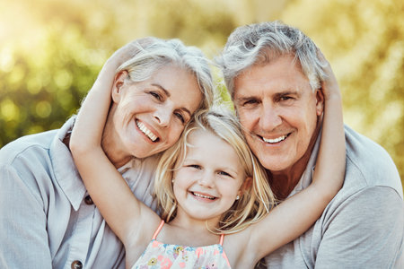 Grandparents, park and child hug portrait with a young girl and elderly people with love and smile....